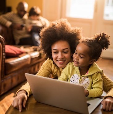 Mother and daughter use a laptop with A&T service
