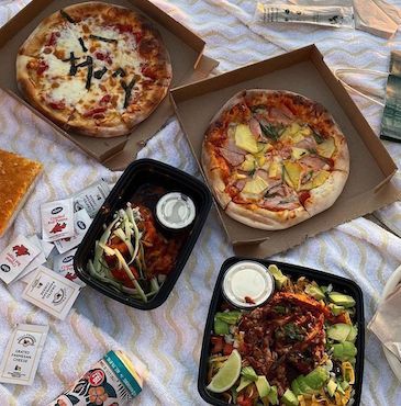 A picnic lunch of pizza and salad from CPK