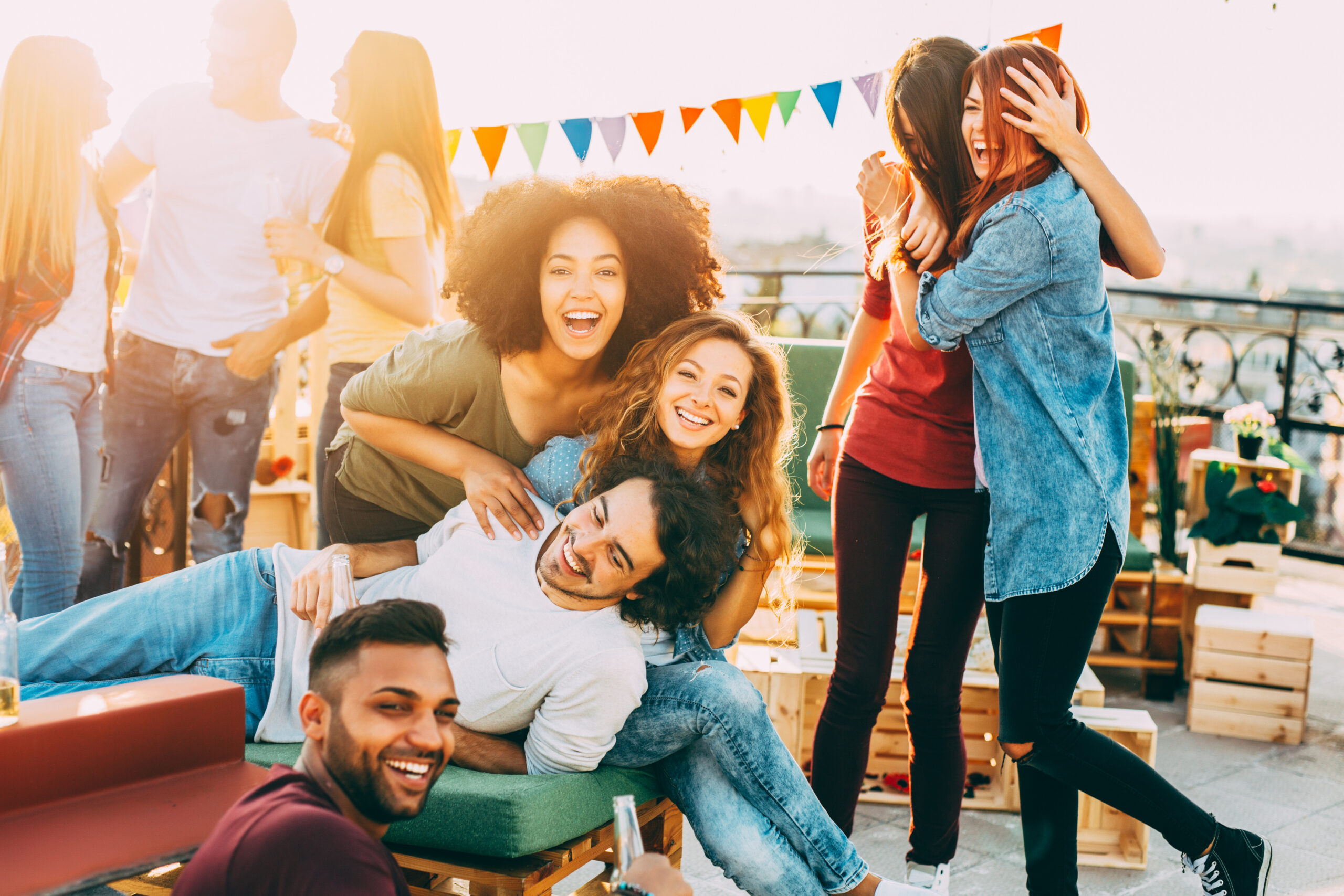 A group of friends having fun at a party on the roof.