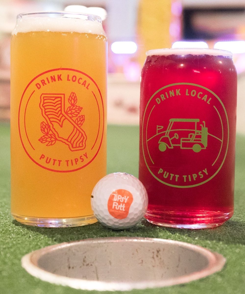 Two pints of beer in front of a golf ball at Tipsy Putt